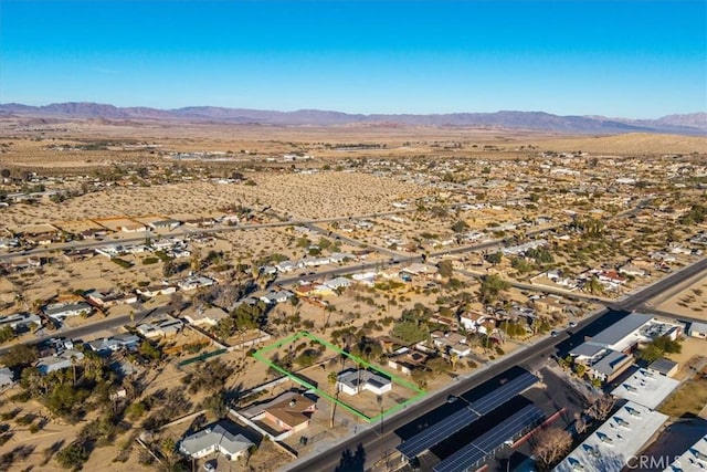 birds eye view of property with a mountain view and view of desert