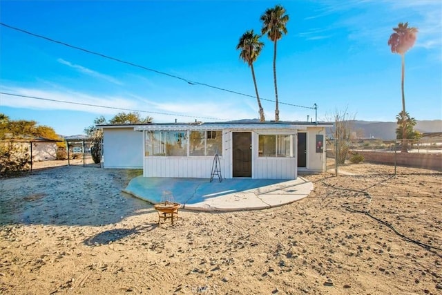 rear view of house with a patio area and fence