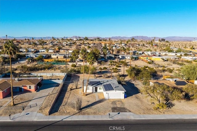 aerial view featuring a residential view, a desert view, and a mountain view