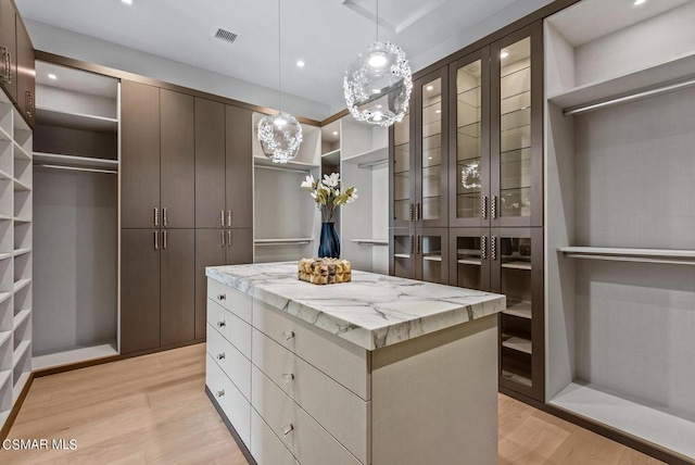 walk in closet featuring light wood-type flooring