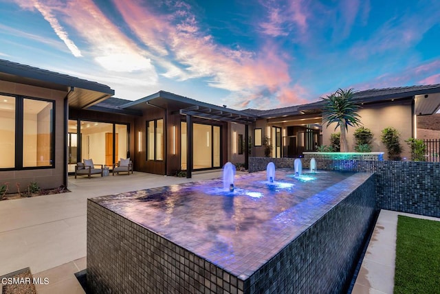 patio terrace at dusk with an outdoor living space