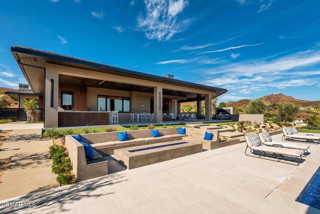 view of patio / terrace with a mountain view and an outdoor fire pit