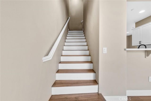 staircase featuring hardwood / wood-style floors