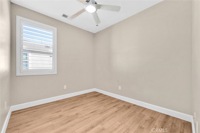 spare room with ceiling fan and light wood-type flooring