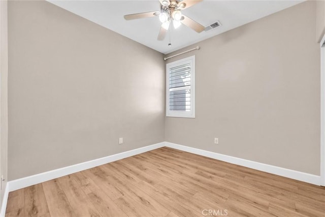 spare room with light wood-type flooring and ceiling fan