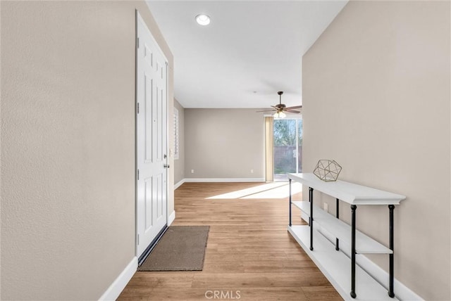 corridor with light hardwood / wood-style flooring