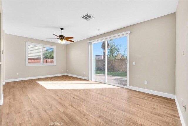 empty room featuring ceiling fan and light wood-type flooring