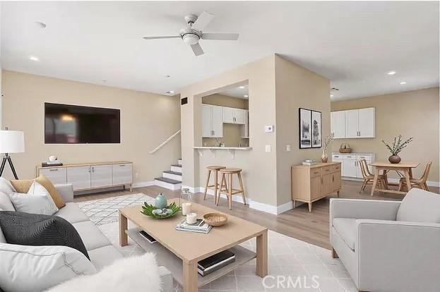 living room with ceiling fan and light hardwood / wood-style floors