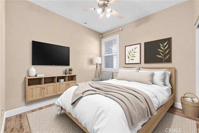 bedroom with ceiling fan and light hardwood / wood-style floors