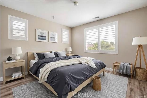 bedroom with hardwood / wood-style flooring