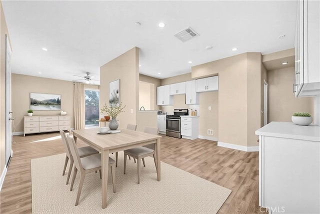 dining room with ceiling fan and light hardwood / wood-style floors