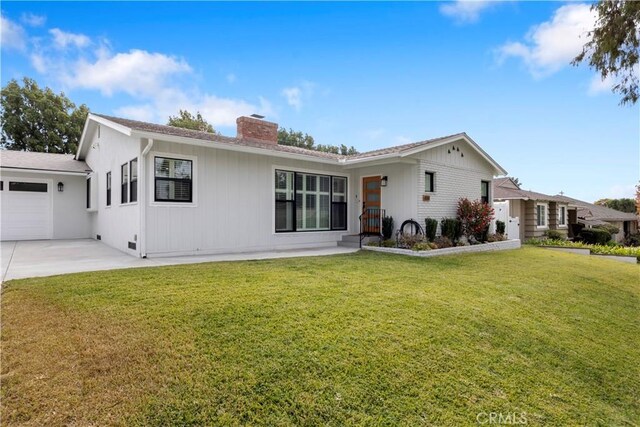 ranch-style house with a front lawn and a garage