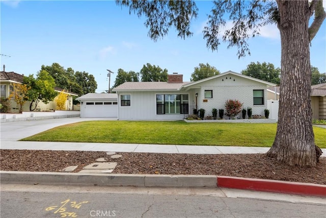 single story home featuring a front lawn and a garage