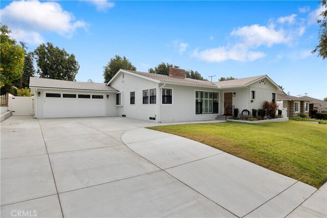 single story home featuring a front yard and a garage