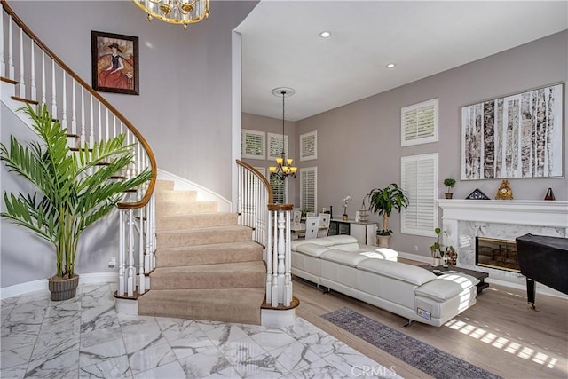 living room with a premium fireplace and an inviting chandelier