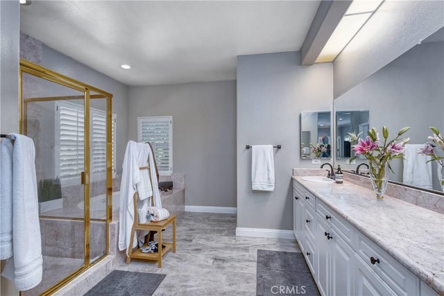 bathroom with a shower with door and vanity