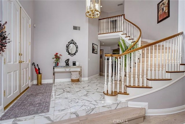 entrance foyer with a high ceiling and a chandelier