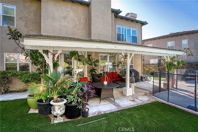 back of house featuring a patio area and a yard