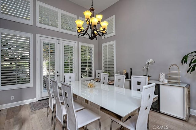 dining space with a chandelier and light hardwood / wood-style flooring