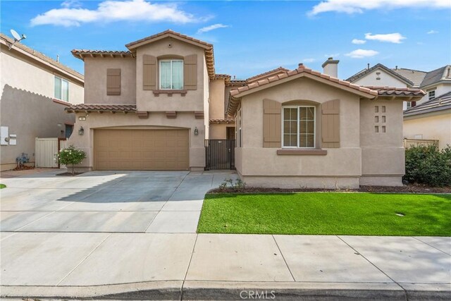 mediterranean / spanish-style home with a garage