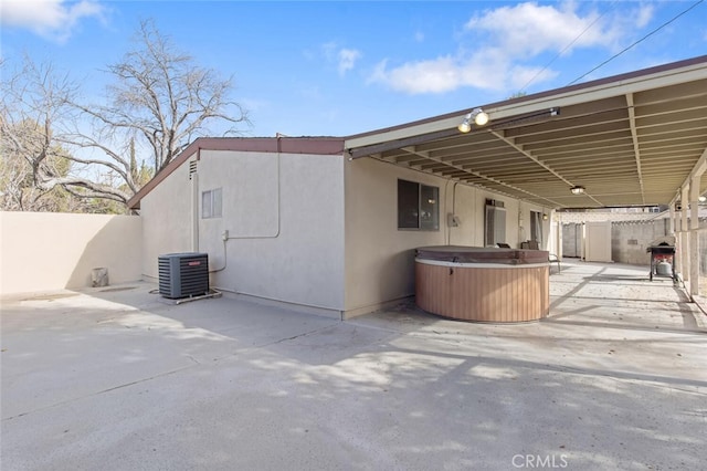 view of side of property featuring cooling unit and a patio