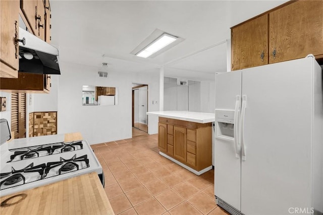 kitchen with white appliances and light tile patterned floors