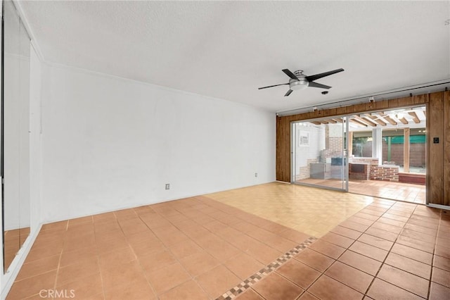 unfurnished living room with ceiling fan and light tile patterned flooring