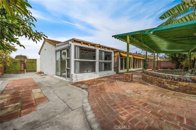 exterior space featuring a jacuzzi and a patio area