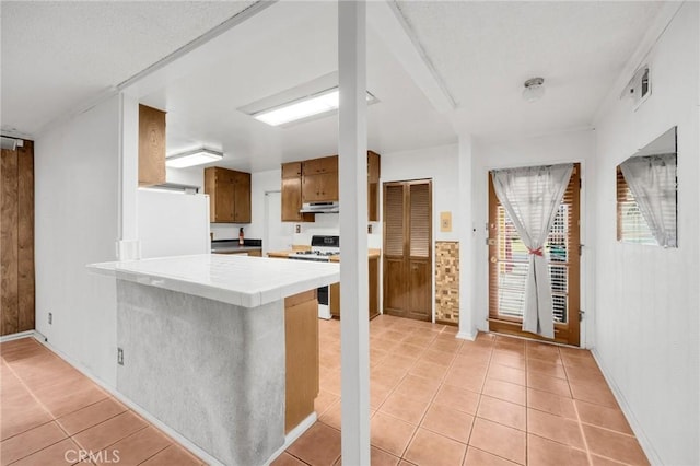 kitchen with tile counters, kitchen peninsula, light tile patterned flooring, and white appliances