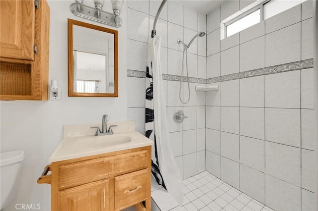 bathroom with toilet, vanity, and curtained shower