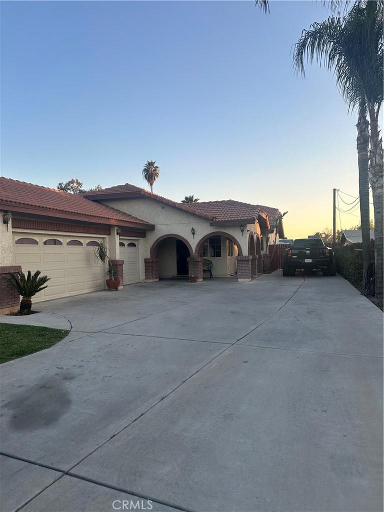 mediterranean / spanish-style house with a garage