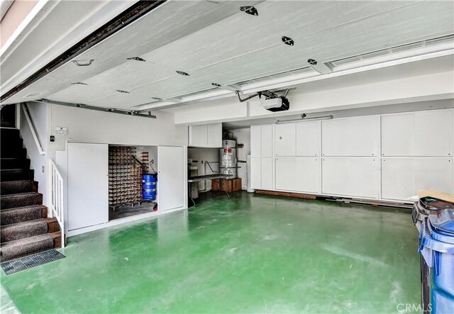 garage with a garage door opener and secured water heater