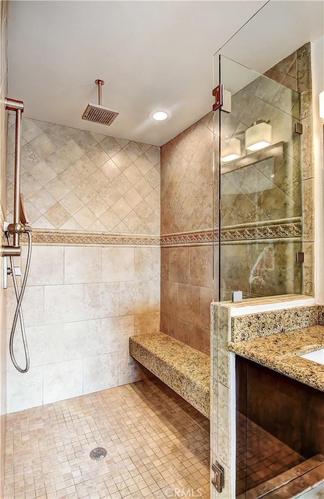 bathroom featuring vanity and an enclosed shower