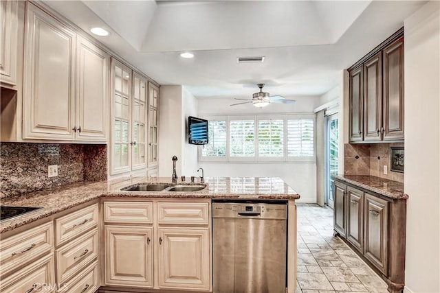 kitchen with sink, light stone countertops, dishwasher, and ceiling fan