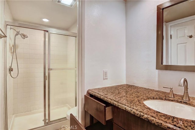 bathroom with an enclosed shower and vanity