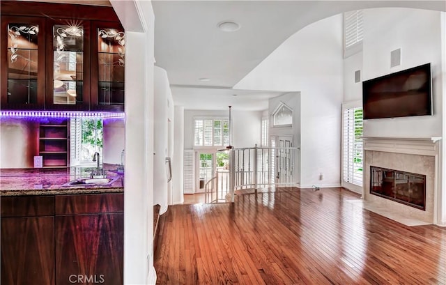 interior space featuring plenty of natural light, sink, a fireplace, and light hardwood / wood-style flooring