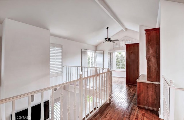 corridor with dark hardwood / wood-style flooring and vaulted ceiling with beams