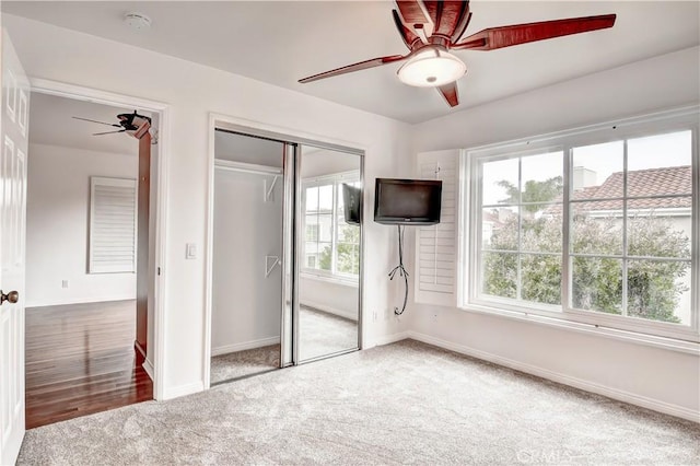 unfurnished bedroom featuring carpet floors and ceiling fan