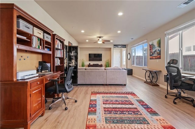 office space with light hardwood / wood-style floors and ceiling fan