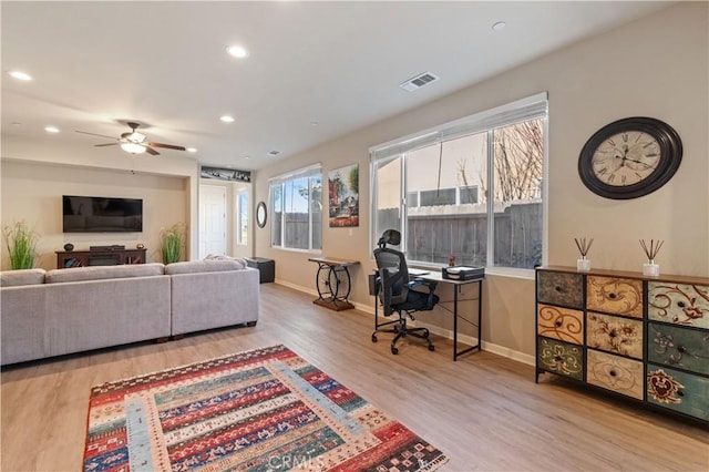 living room with light wood-type flooring and ceiling fan