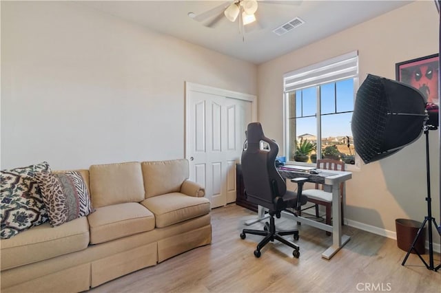 home office featuring ceiling fan and light hardwood / wood-style flooring