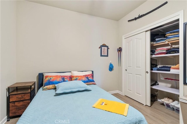 bedroom featuring light wood-type flooring and a closet