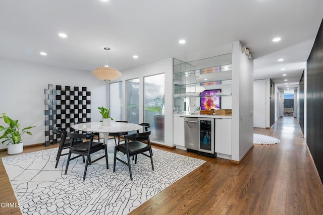 dining area featuring hardwood / wood-style floors and beverage cooler