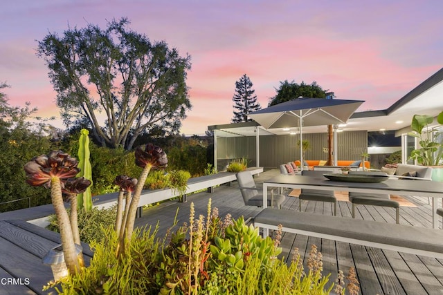 deck at dusk featuring outdoor lounge area