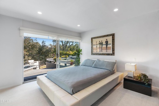 bedroom with light carpet and access to exterior