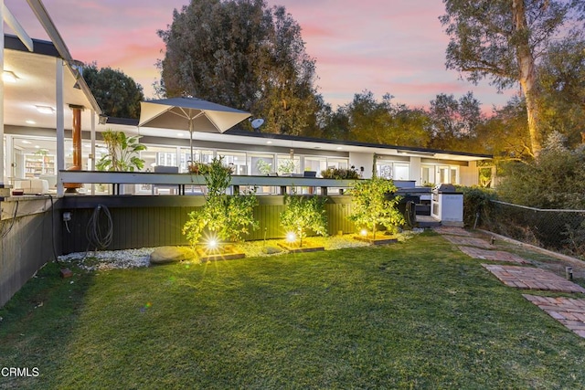 view of yard at dusk