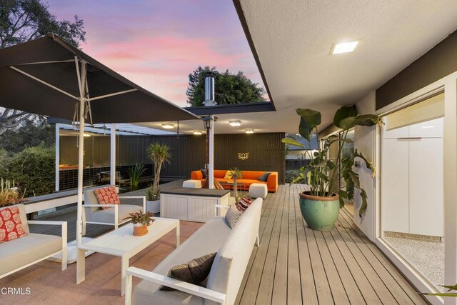 balcony at dusk with an outdoor living space