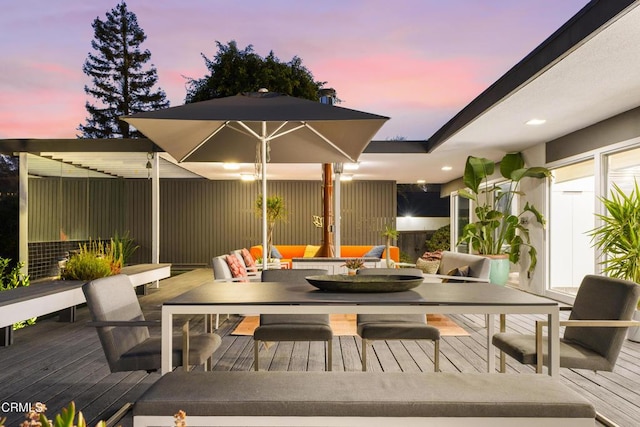 deck at dusk featuring an outdoor living space