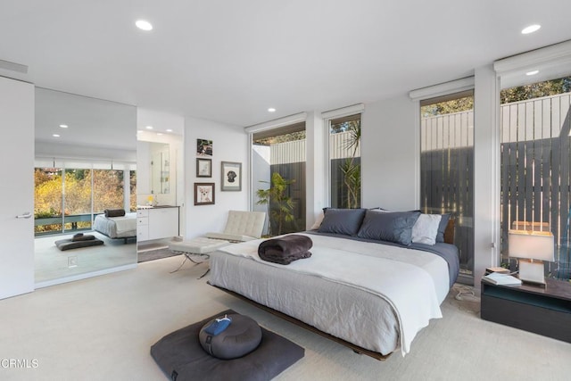 bedroom with light carpet and expansive windows