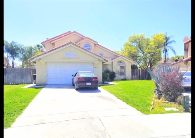 view of front of property featuring a front yard and a garage